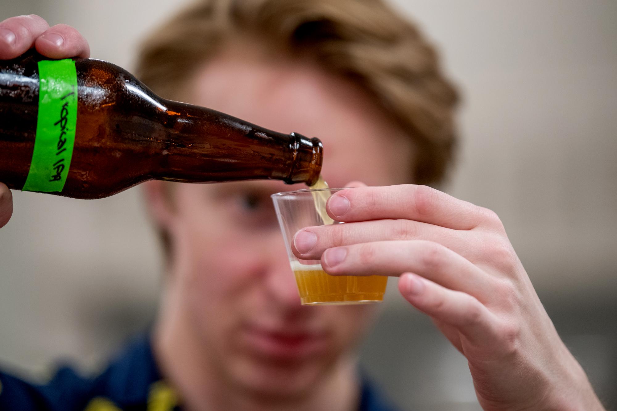 Garret tasting a beer in brewing class.